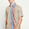 Short sleeves shirt Desain ethnic dalam motif batik Pointed collar, hidden button opening Left chest pocket Material : Cotton primis